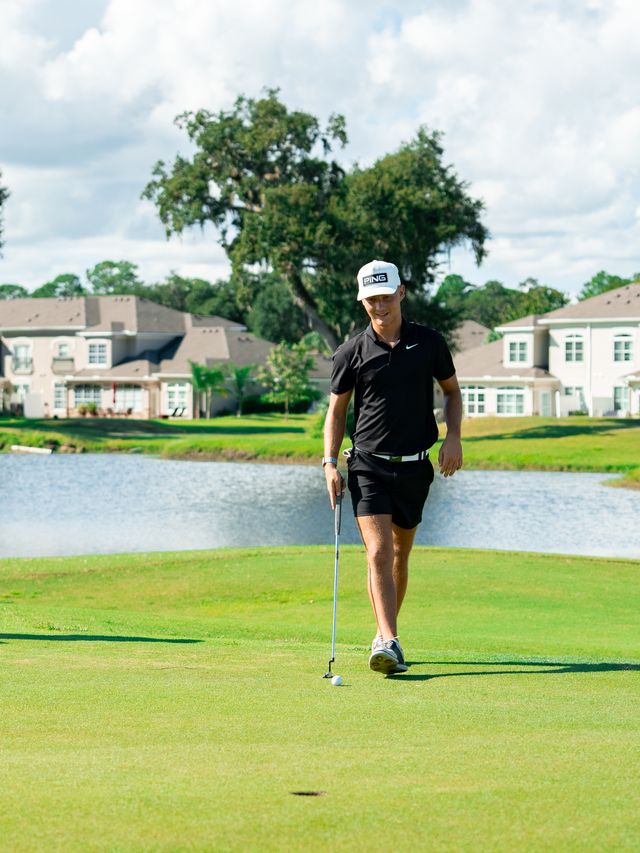 A DME golfer walking up to the green during a round.